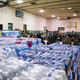 Bottled water can be seen on a gym floor in Flint, Mich., during a March 17, 2016, town hall meeting related to the lead-water crisis.